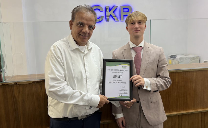 Man presents a certificate to student